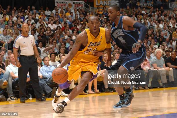 Kobe Bryant of the Los Angeles Lakers drives against C.J. Miles of the Utah Jazz in Game Two of the Western Conference Quarterfinals during the 2009...