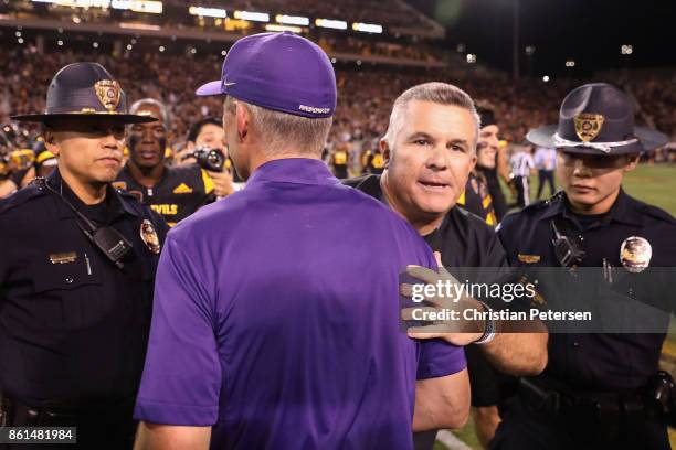 Head coaches Todd Graham of the Arizona State Sun Devils and Chris Peterson of the Washington Huskies shake hands following the college football game...