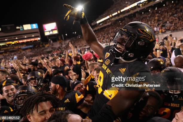 Wide receiver Frank Darby of the Arizona State Sun Devils celebrates with teammates on the field after defeating the Washington Huskies in the...
