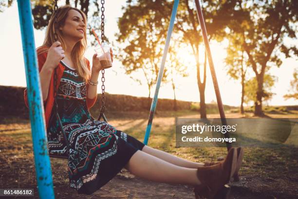 beautiful woman swinging on the swining chair - swining stock pictures, royalty-free photos & images