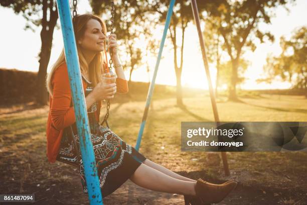 beautiful woman swinging on the swining chair - swining stock pictures, royalty-free photos & images