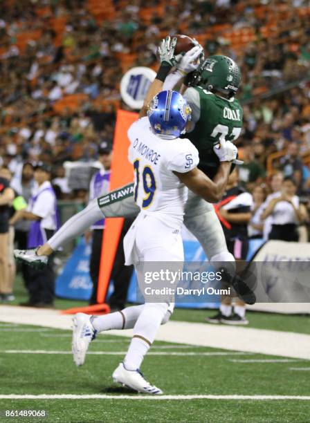 Dylan Collie of the Hawaii Rainbow Warriors makes a reception in the end zone as he is closely guarded by Dakari Monroe of the San Jose State...