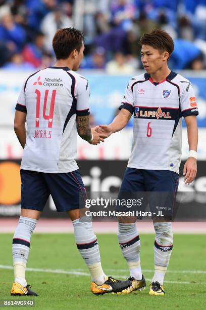 Jang Hyun Soo and Kosuke Ota of FC Tokyo shake hands after the 1-1 draw in the J.League J1 match between Ventforet Kofu and FC Tokyo at Yamanashi...