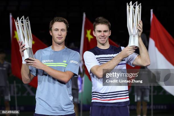 Henri Kontinen of Finland and John Peers of Australia pose with their trophy after winning the Men's doubles final match against Marcelo Melo of...