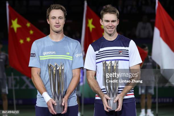 Henri Kontinen of Finland and John Peers of Australia pose with their trophy after winning the Men's doubles final match against Marcelo Melo of...