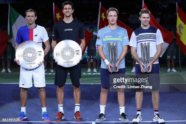 Lukasz Kubot of Poland, Marcelo Melo of Brazil, Henri Kontinen of Finland and John Peers of Australia pose with their trophy after the Men's doubles...