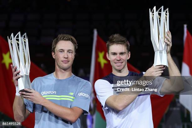 Henri Kontinen of Finland and John Peers of Australia pose with their trophy after winning the Men's doubles final match against Marcelo Melo of...