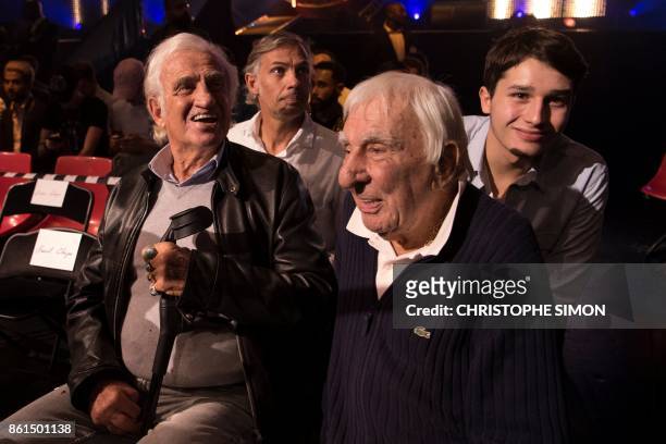 French actors Charles Gerard and Jean-Paul Belmondo , his son Paul and grandson Giacomo Belmondo look on prior to attending a heavyweight bout at the...