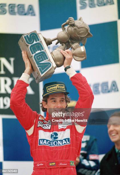 Brazilian racing driver Ayrton Senna with the trophy after winning the European Grand Prix at Donnington Park in a McLaren-Cosworth, 11th April 1993.