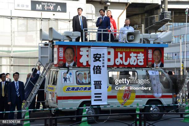 Shinzo Abe, Japans prime minister and president of the Liberal Democratic Party , center, speaks during an election campaign rally in Sapporo,...