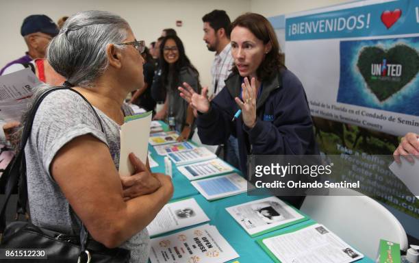 From left, Beatriz Rodriguez talks with Gloria 'Gigi' Rivadeneyra, program manager for the Florida Department of Health, Seminole County, who set up...