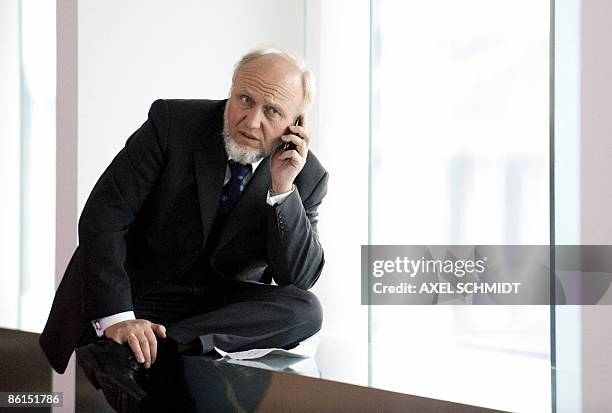 The President of the IFO Institute for Economy Research Hans-Werner Sinn makes a phoen call prior to a meeting presided by German Chancellor Angela...
