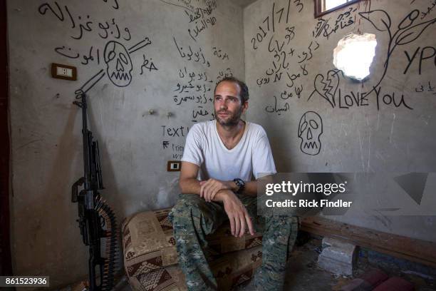 British volunteer fighter 'Macer Gifford' sits in one of his locations which he uses to fire his sniper rifle targeting ISIS on August 18, 2017 in...
