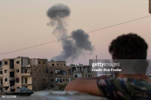 Smoke rises from a building believed to be housing ISIS, after being hit by a mortar round fired from a United States military base on August 18,...