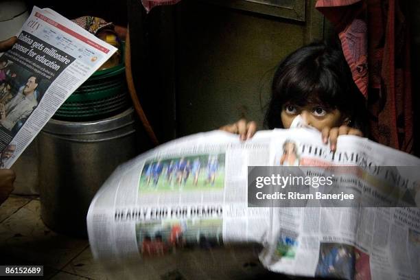 Rubina Ali, of Slumdog Millionaire fame, sits with newspapers inside her home at Garib Nagar, April 22, 2009 in the slums of Bandra, Mumbai. The...