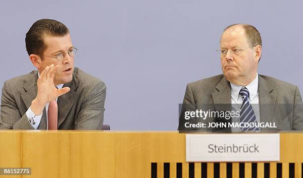 German Finance Minister Peer Steinbrueck and German Economy Minister Karl-Theodor zu Guttenberg address a press conference in Berlin April 22,...