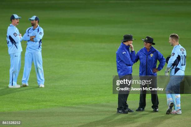 Umpires Phillip Gillespie and John Ward talk to Peter Nevill of NSW during the JLT One Day Cup match between New South Wales and Victoria at North...