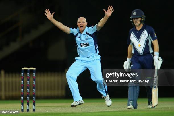 Doug Bollinger of NSW celebrates taking the wicket of Matt Short of Victoria during the JLT One Day Cup match between New South Wales and Victoria at...