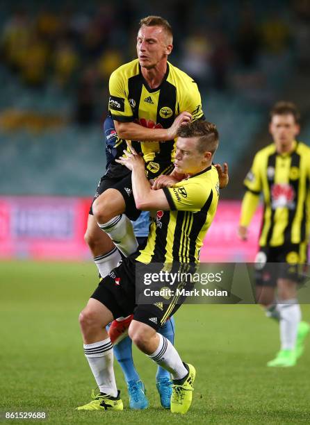 Goran Paracki and Scott Galloway of Wellington contest possesion with Milos Ninkovic of Sydney during the round two A-League match between Sydney FC...