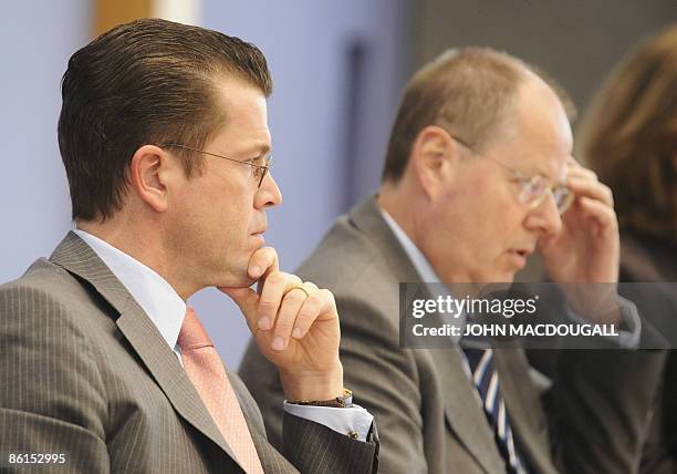 German Finance Minister Peer Steinbrueck and German Economy Minister Karl-Theodor zu Guttenberg address a press conference in Berlin April 22,...