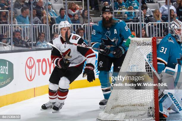Brent Burns of the San Jose Sharks and Lawson Crouse of the Arizona Coyotes skate behind the net] at SAP Center at San Jose on September 30, 2017 in...