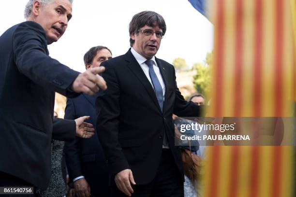 Catalan regional government president Carles Puigdemont prepares to lay a wreath at a monument honouring civil war victims on the sidelines of a...
