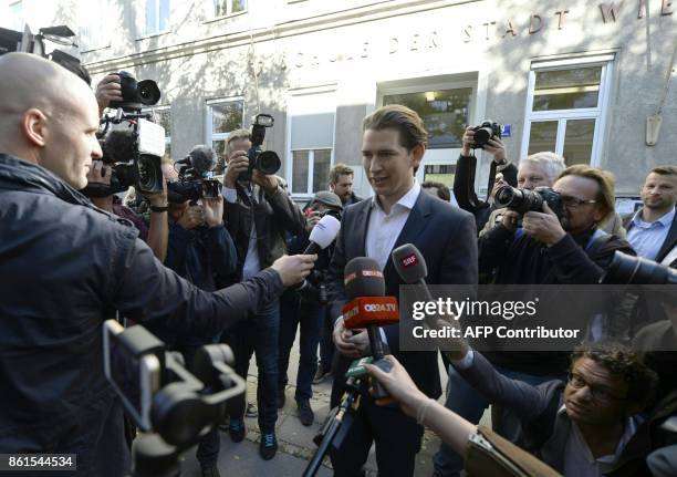 Austria's Foreign Minister and leader of Austria's centre-right People's Party Sebastian Kurz talks with journalists in front of a polling station...