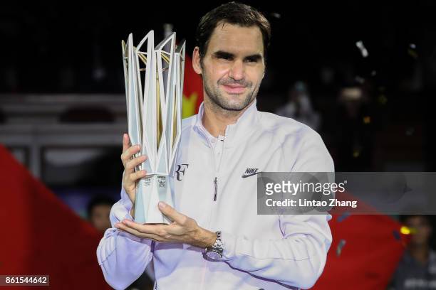 Roger Federer of Switzerland poses with the winner's trophy after defeating Rafael Nadal of Spain duirng the Men's singles final mach on day eight of...