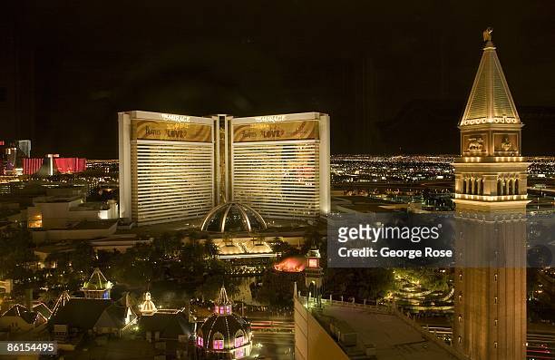 Brightly lit Mirage Hotel, located on the famed Las Vegas Strip and featuring an erupting volcano, is seen across the street from the Venetian Hotel...
