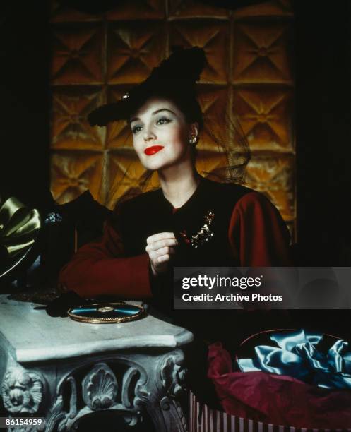 Well-dressed woman with an open hatbox, circa 1940.