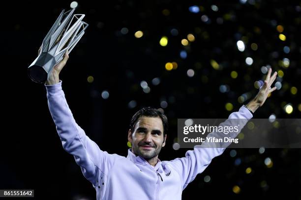 Roger Federer of Switzerland poses with the trophy during the award ceremony after winning his Men's singles final match against Rafael Nadal of...