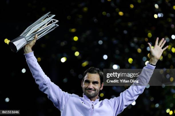 Roger Federer of Switzerland poses with the trophy during the award ceremony after winning his Men's singles final match against Rafael Nadal of...