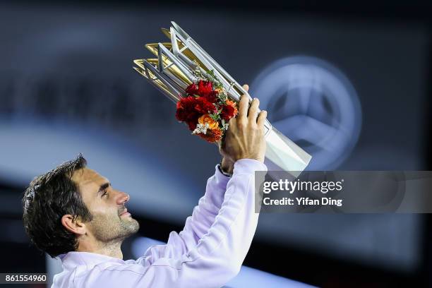 Roger Federer of Switzerland poses with the trophy during the award ceremony after winning his Men's singles final match against Rafael Nadal of...