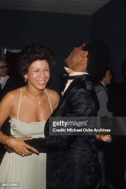 Singer Minnie Riperton and Stevie Wonder chat at an event in circa 1975.
