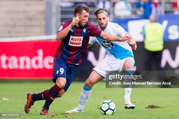 Sergi Enrich of SD Eibar duels for the ball with Raul Albentosa of RC Deportivo La Coruna during the La Liga match between SD Eibar and RC Deportivo...