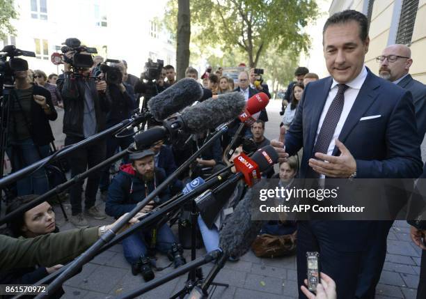 Heinz-Christian Strache , chairman of Austria's far-right Freedom Party , speaks with journalists in front of a polling station during general...