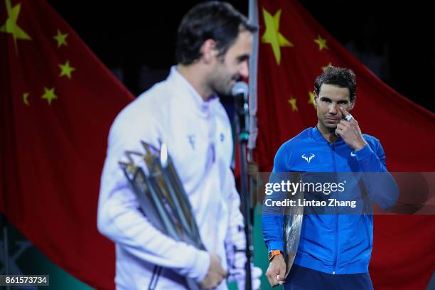 Rafael Nadal of Spain reacts with runner-up trophy during the award ceremony after losing his Men's singles final match against Roger Federer of...