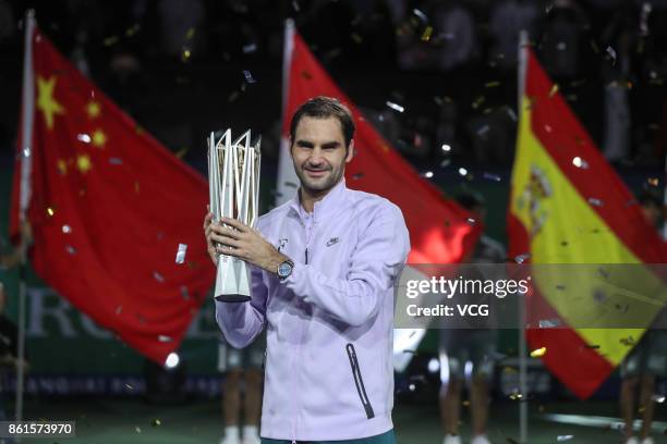 Winner Roger Federer of Switzerland poses with the his trophy after defeating Rafael Nadal of Spain during the Men's singles final mach on day eight...