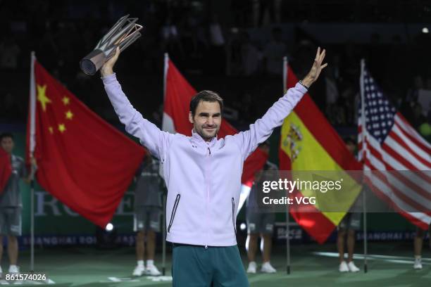 Winner Roger Federer of Switzerland poses with the his trophy after defeating Rafael Nadal of Spain during the Men's singles final mach on day eight...