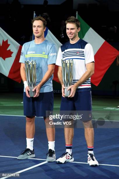 Henri Kontinen of Finland and John Peers of Australia pose with their trophies after winning the Men's doubles final match against Marcelo Melo of...