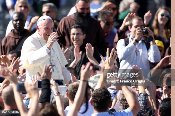 Pope Francis waves to the faithful as he leaves St. Peter's Square at the end of a canonisation ceremony on October 15, 2017 in Vatican City,...