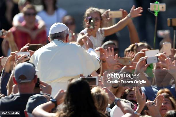 Pope Francis waves to the faithful as he leaves St. Peter's Square at the end of a canonisation ceremony on October 15, 2017 in Vatican City,...