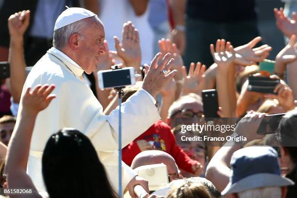 Pope Francis waves to the faithful as he leaves St. Peter's Square at the end of a canonisation ceremony on October 15, 2017 in Vatican City,...