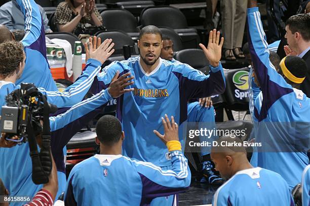 Tyson Chandler of the New Orleans Hornets high fives his teammates as he enters the court during player introductions prior to the game against the...