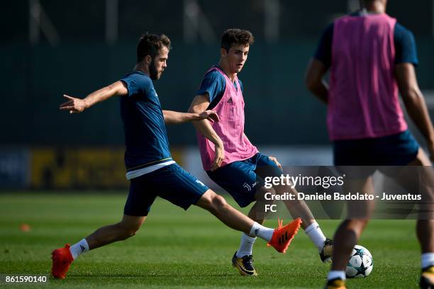 Miralem Pjanic and Fabrizio Caligara during a Juventus traininig session at Juventus Center Vinovo on October 15, 2017 in Vinovo, Italy.