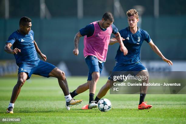 Alex Sandro , Stefano Sturaro and Daniele Rugani during a Juventus traininig session at Juventus Center Vinovo on October 15, 2017 in Vinovo, Italy.