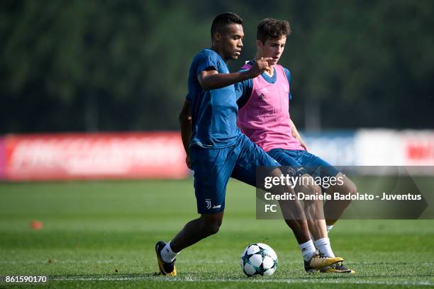 Alex Sandro and Fabrizio Caligara during a Juventus traininig session at Juventus Center Vinovo on October 15, 2017 in Vinovo, Italy.