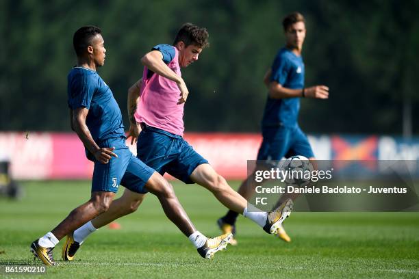 Alex Sandro and Fabrizio Caligara during a Juventus traininig session at Juventus Center Vinovo on October 15, 2017 in Vinovo, Italy.