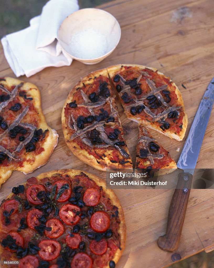 Pizzas with anchovies and tomatoes