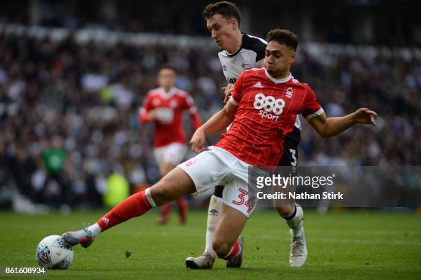 Tyler Walker of Nottingham Forest and Craig Forsyth of Derby in action during the Sky Bet Championship match between Derby County and Nottingham...